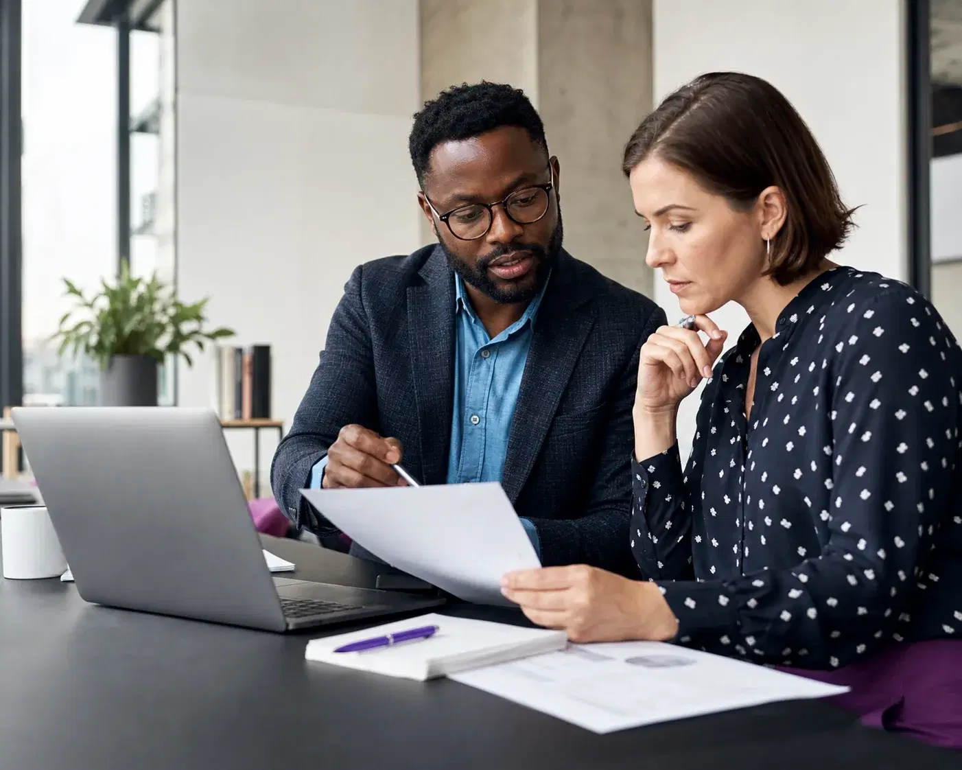 Two recruiters comparing candidate evidence together